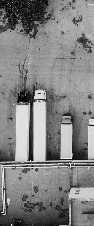 Aerial view of a warehouse with trucks parked ready to be loaded