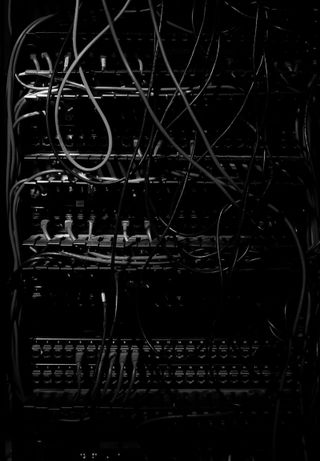 Parts of a dimly lit server rack