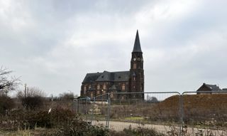 "The vacated church in Manheim. All windows have been barricaded. In the front you see some construction fences."
